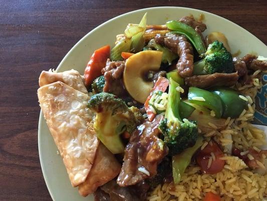 Hunan beef with fried rice and an egg roll.