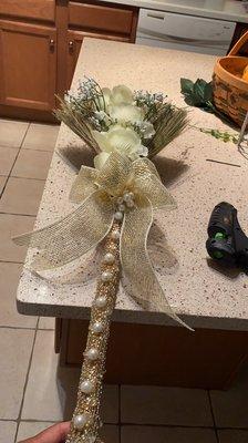 This is a Broom I made for my wedding ceremony and all the items that took to decorate the broom were from the Dollar Tree.