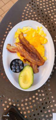 keto plate with scrambled eggs. blueberries and 1/2 avacado