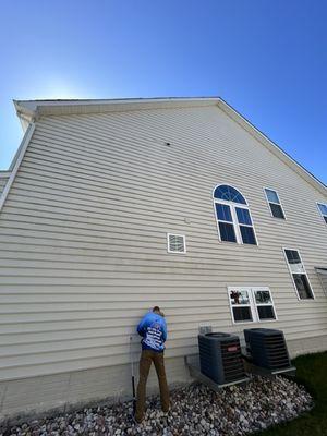 Taping up an Internet box to deter water intrusion prior to pressure washing service in Lake Ridge, VA.