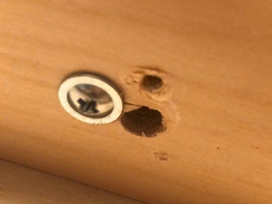 Bungled, misaligned holes in almost every drawer and splintered wood.