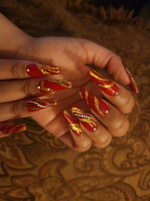 Red Coffin Nails with Gold Curved lines and Rhinestones