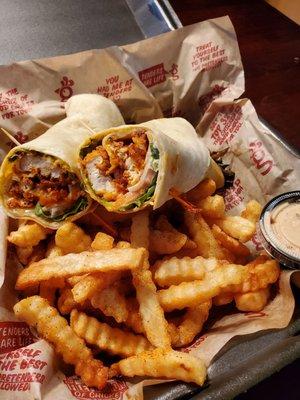 Breaded Buffalo wrap with fries, extra seasoning and a side of Magoo sauce