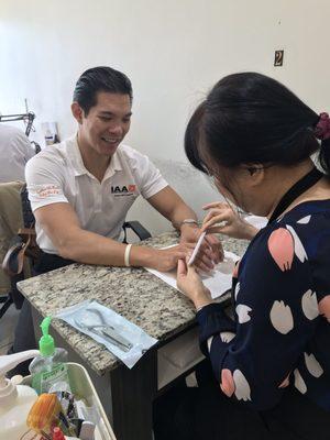 Guys can get manicures too. They had the NFL game on for him