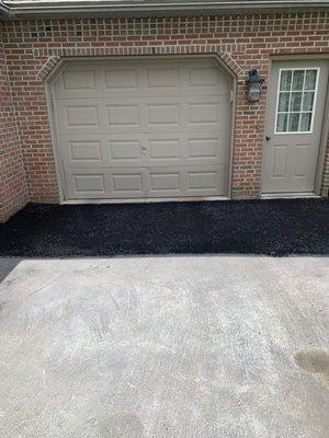 Picture shows new asphalt patch but the real work was repair of the foundation below the patch.