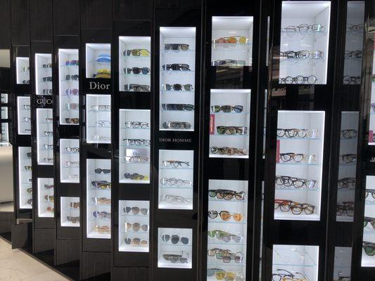 Different sunglasses on the wall (huge selection)