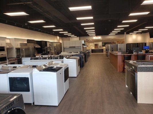 appliance showroom with multiple washing machine appliances on display