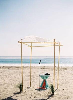 This beachy arch is covering a tall 36 inch cocktail table covered in tiffany blue polyester linen. Contact us for your next event!