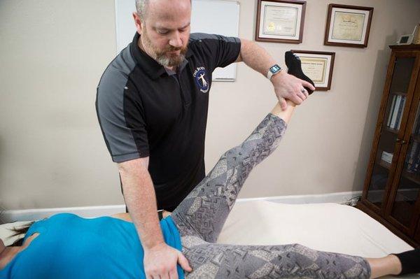 Muscle-testing a hip flexor.