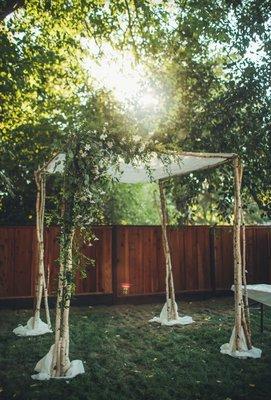 Rental Chuppah from Kay with added branches and asymmetrical floral arrangement