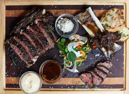 Beef Flight for Two: 27oz Bone-in Ribeye, A-5 Kobe Striploin, bone marrow, wagyu beef cheek marmalade, garlic crostini, pickled vegetables