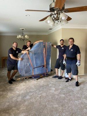 A baby grand piano moved cross country by Gentlemen's moving team