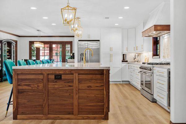 Transformed the space by knocking down walls, to create an open floor plan. Added 12ft island and customized a door to pantry & laundry.