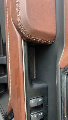 Grease Stains On Leather and white stitching. The area by window switches was cleaned to verify the grease on the door handle area.