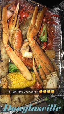 Crawfish, crab legs, shrimp, broccoli , corn, and potatoes