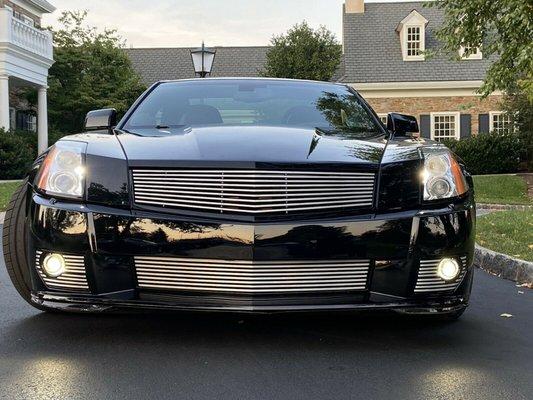 Fully customized Cadillac XLR sporting custom grills built in-house out of 6061 aluminium. The upper grill was machined from a single block