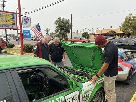 Owner, John, with lead technician Dan Pluth, and Service Writer Bruno Casillas looking at our newest race car project!