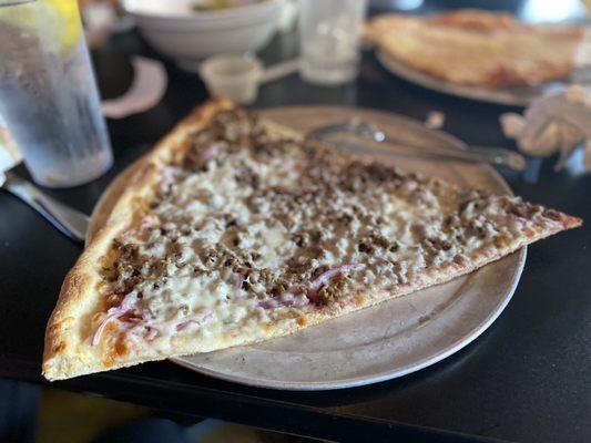 Huge slice of ground beef/onion pizza