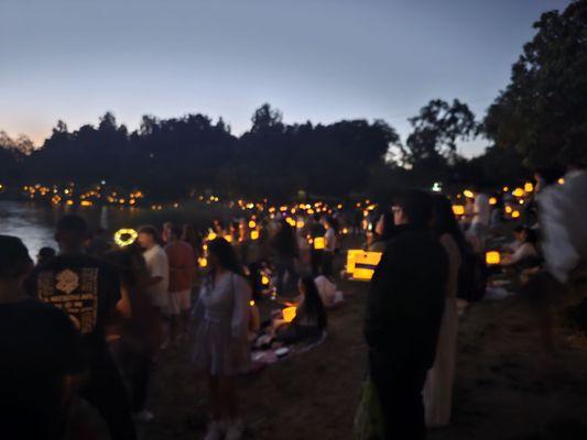 People with their water lanterns to be released.