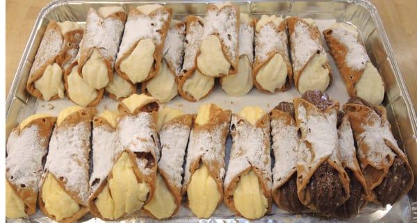 Cannolis oozing with fresh creamy filling