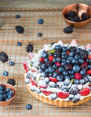 Wild Berry Tort! Flaky butter cookie crust, dark chocolate, vanilla yogurt cake, Bavarian cream, and tons of seasonal fresh berries!