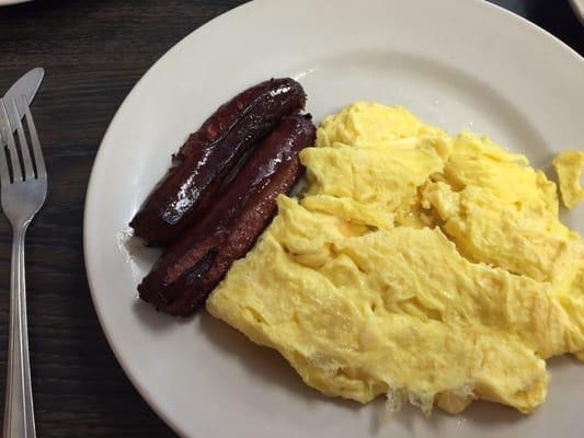 Scrambled eggs with cheese and hot beef links.