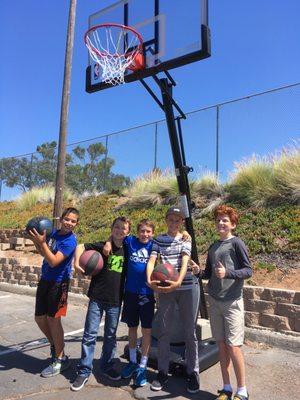 Middle school boys with basketballs in P.E.