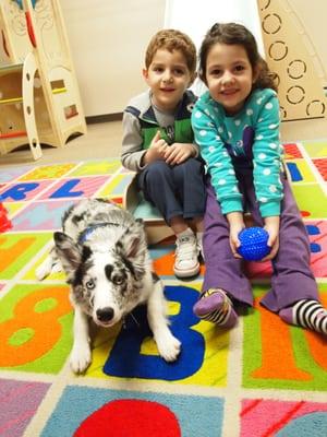 Family of staff at the center to visit with Fritz, our therapy dog in training!