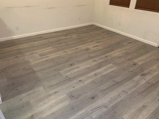 Living room area after vinyl flooring installation.