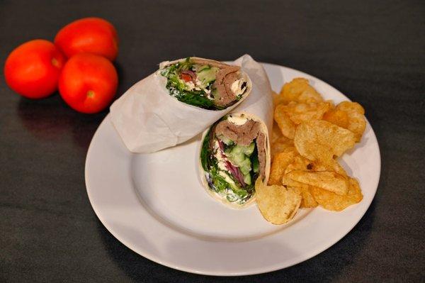 Platter or box lunch. Greek steak wrap with cucumber, kalamata olives, feta cheese and ripe tomato and seasonal greens.