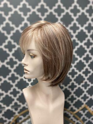 Layered bob. Soft fringe bang.  Light blonde to brown at the nape.