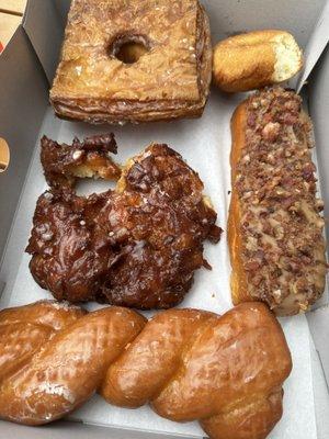 Apple fritter, glaze twist, bacon/ maple bar, plain cake donuts