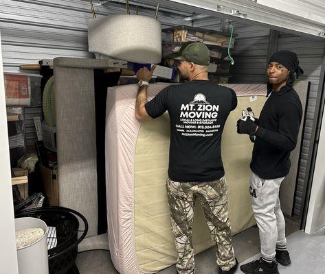 Malcom and Kilo with perfectly filled ( JENGA) packed storage unit. Praise God, they were amazing young men!