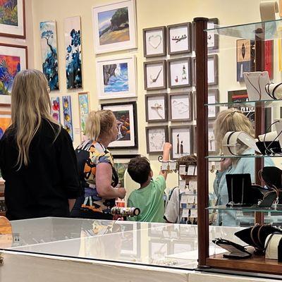 Folks enjoying Maui sea glass art by Beba