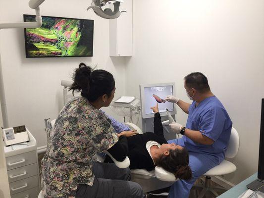 Dr. Nishihara uses our 3-D intra-oral scanner during an examination appointment.