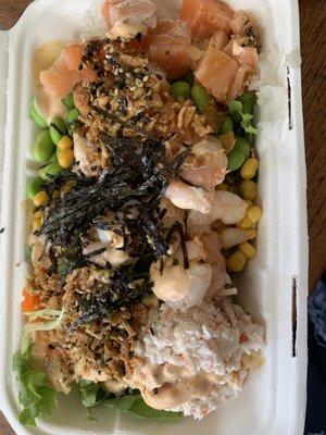 Half rice, half salad, crab, shrimp, and salmon