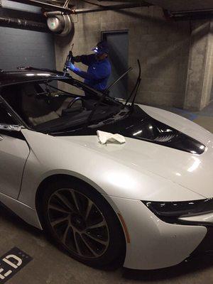 Erick, our Master of Luxury Technician, busy at work replacing the windshield on a 2016 BMW i8