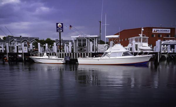 Two classic New England Hulls taking on fuel at MacDougalls' Cape Cod Marine Service's 90'-face, fuel dock.