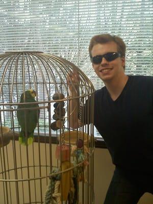 My brother just got his braces off and decided to pose with Dr. Weed's parrot.