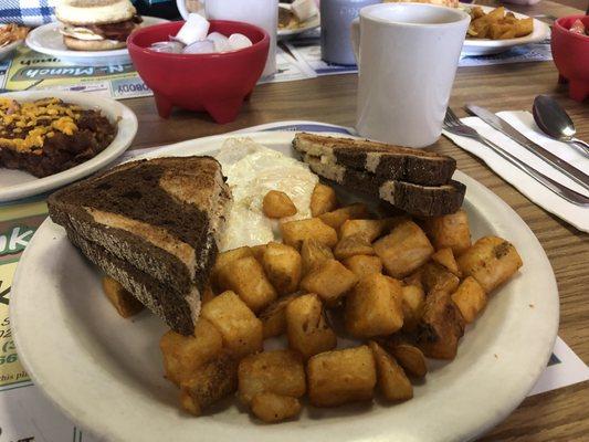 Fried eggs marble rye and home fries.