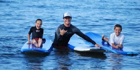 Zack with 2 new surfers catching waves in Maui.