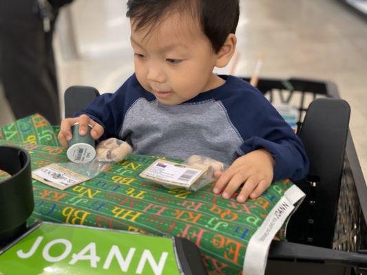 Mommy and me time. Little one enjoying his time getting to chose his fabric!