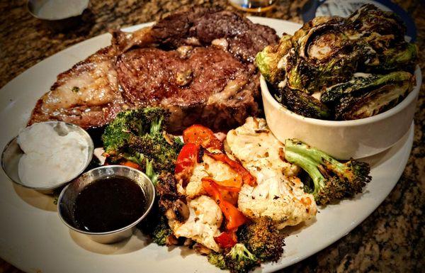 Prime rib, medium rare, with roasted veggies and Sriracha brussel sprouts.