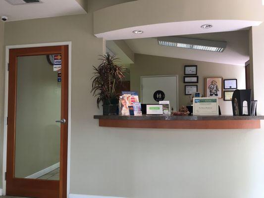 Clean front desk with neutral restroom in the background.