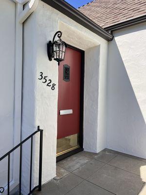 After paint job. Dark Engine on metal rails, house numbers and front door speakeasy. Front door color, Dunn Edwards' Deep Crimson.