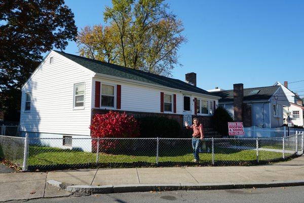 A happy homeowner and their new roof in Roslindale