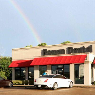 Beautiful rainbow shines like a smile upon this  cosmetic dental office.