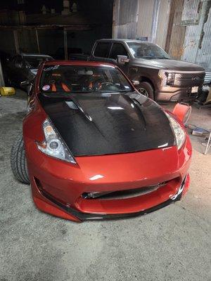 insurance repair. covered a custom front bumper. carbon fiber hood repair and custom carbon layout on the bumper.