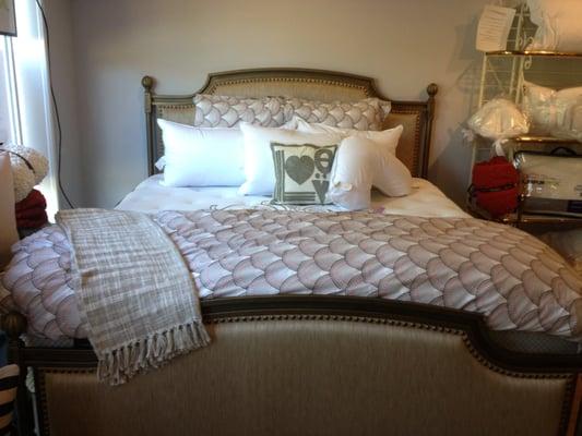 Wesley Allen customizable upholstered bed.  Down pillows by the pillow bar.  Bedding by Jonathan Adler.