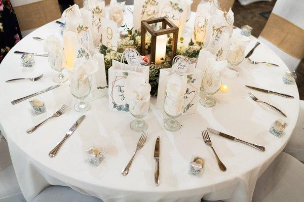 Wedding table setting with linen, flatware and glassware